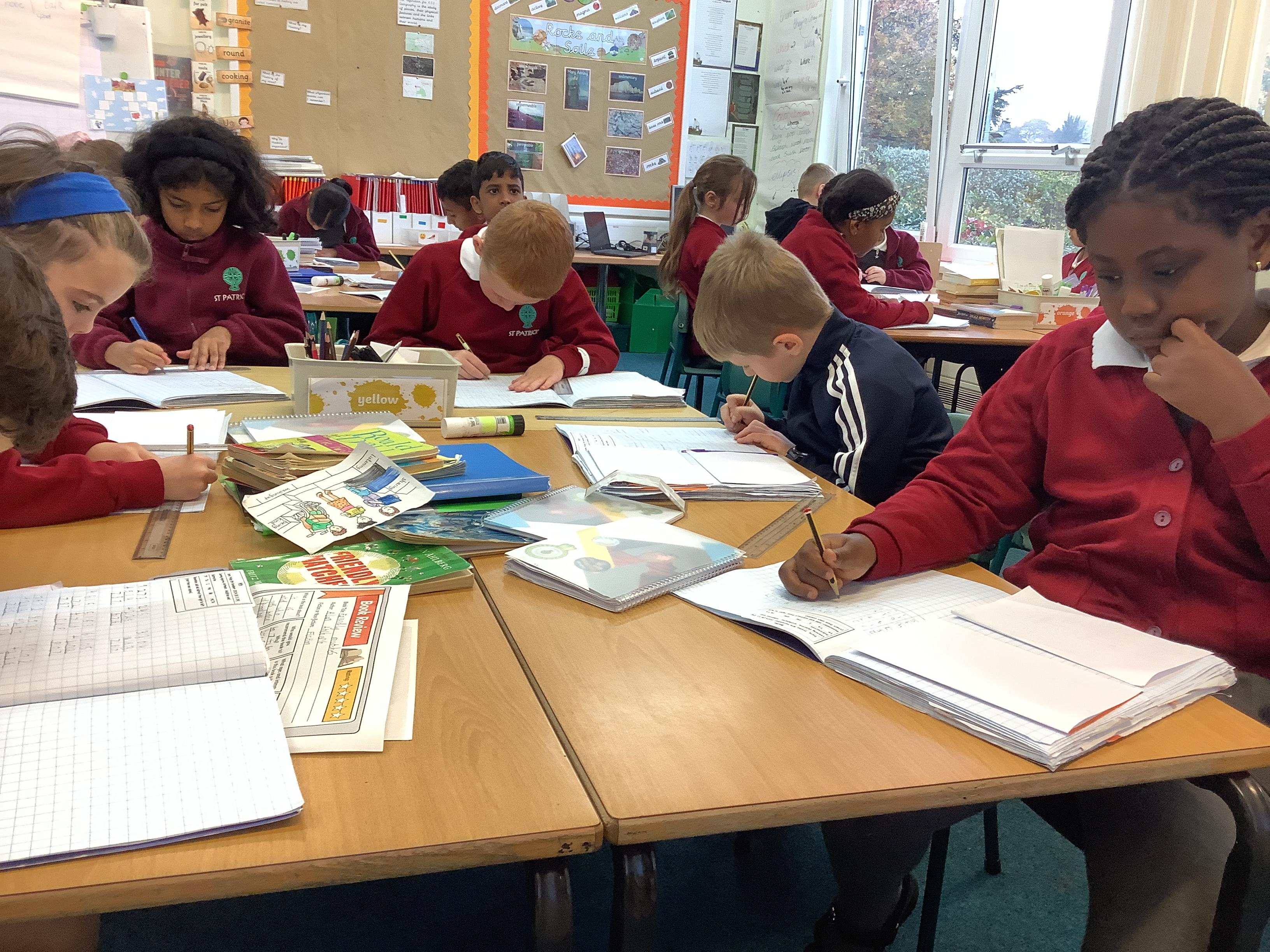 Busy, buzzing brains tackling 3-digit addition and subtraction.